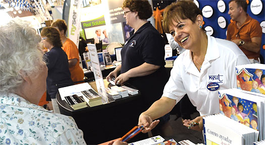 NYSUT Vice President Catalina Fortino hands out rulers and helpful education brochures to passersby at the NYSUT booth at the New York State Fair. NYSUT staff and volunteers from central New York locals operate the booth during the fair's run from late August to Labor Day.